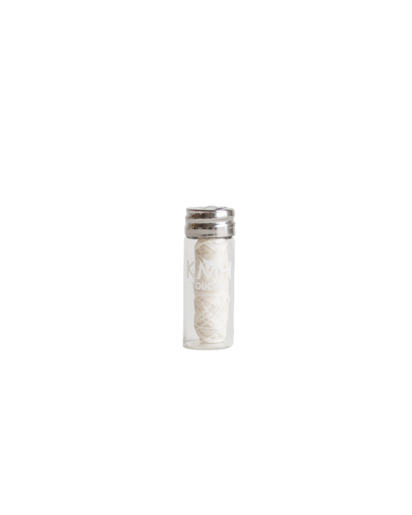 biodegradable silk dental floss in glass mason jar container upright