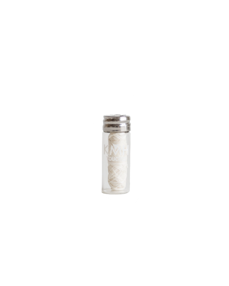 biodegradable silk dental floss in glass mason jar container upright