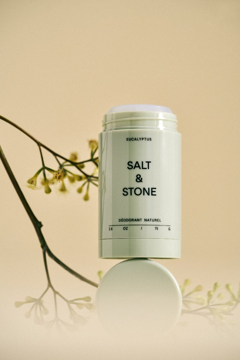 opened salt and stone eucalyptus natural deodorant against peach background