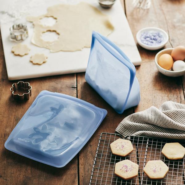 stasher stand up bags on table with baked cookies and cookie cutters