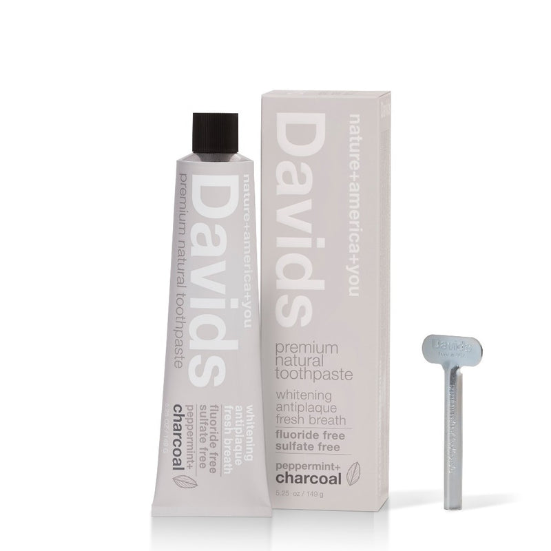 davids premium natural toothpaste charcoal peppermint tub, box and metal key upright with white background