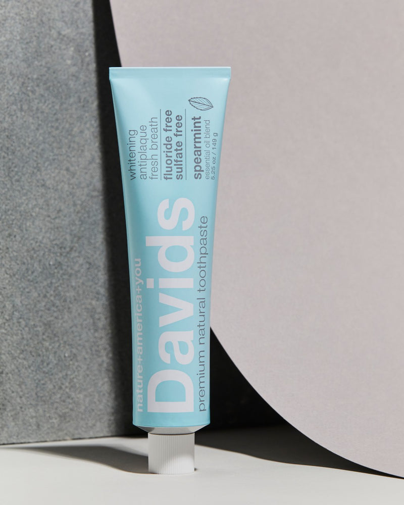 davids natural spearmint toothpaste tube upright on a grey counter