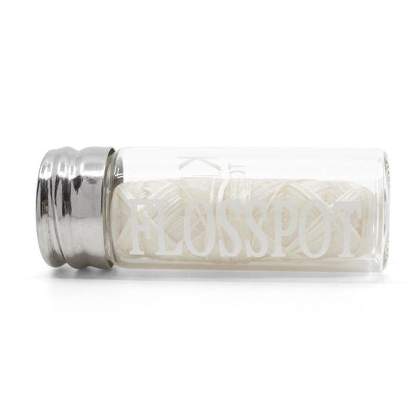 floss pot biodegradable silk dental floss in glass mason jar container laying on side