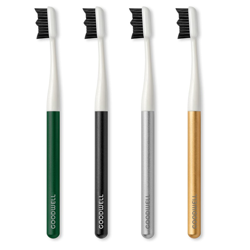 goodwell biodegradable toothbrushes in green, black, silver and gold lined up against white background