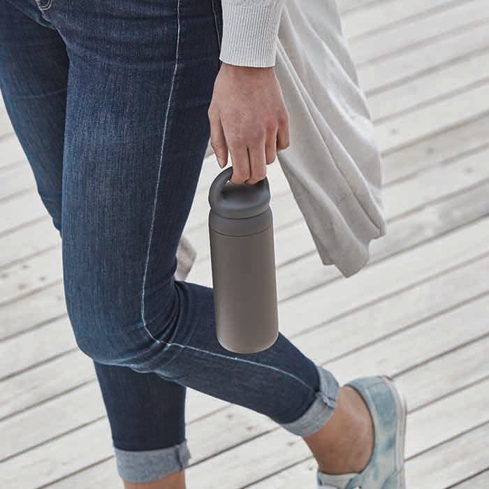 girl walking and holding kinto grey day off tumbler