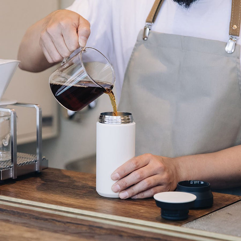 coffee being poured into kinto coffee tumbler