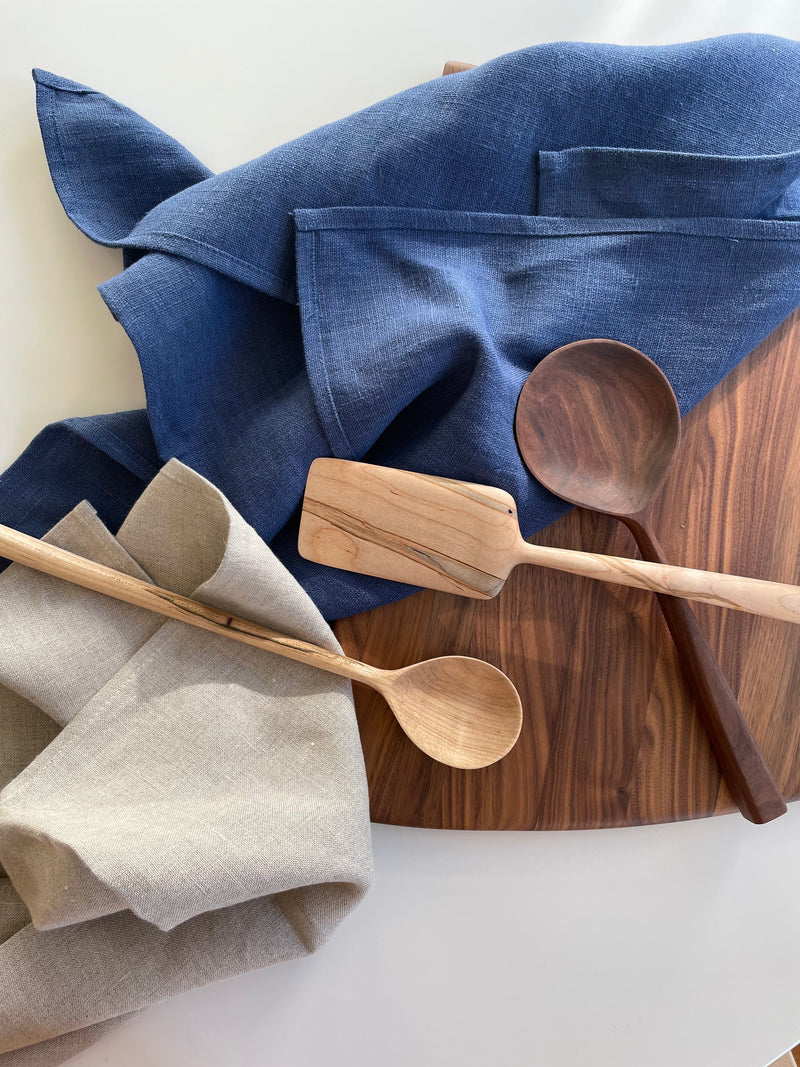 natural linen tea towels with charcuterie board and wooden spoons on table
