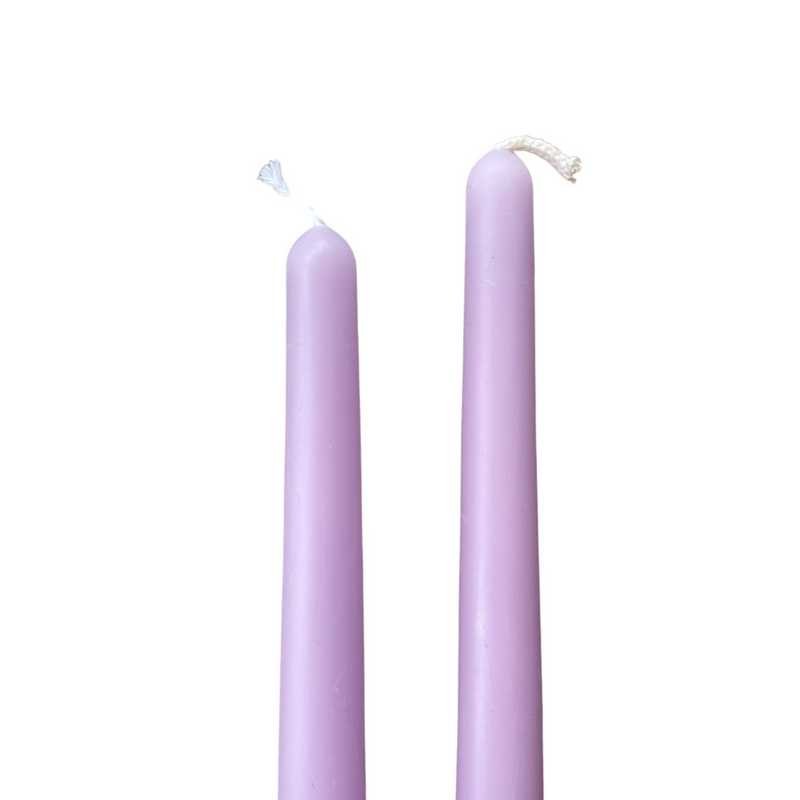 two lavender coloured taper candles