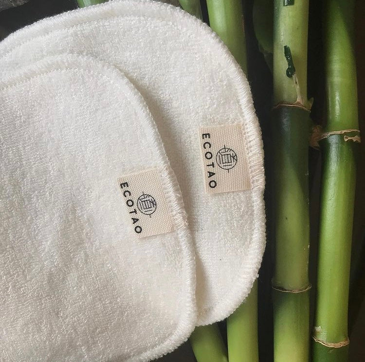 eco tao reusable facial wipes laid on bamboo shoots