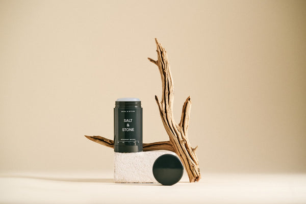 opened salt and stone vetiver and sandalwood deodorant with branch in background