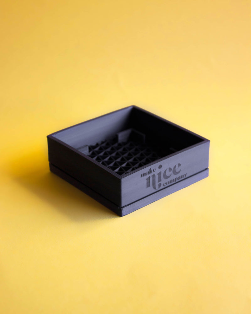 make nice company black soap tray against yellow background