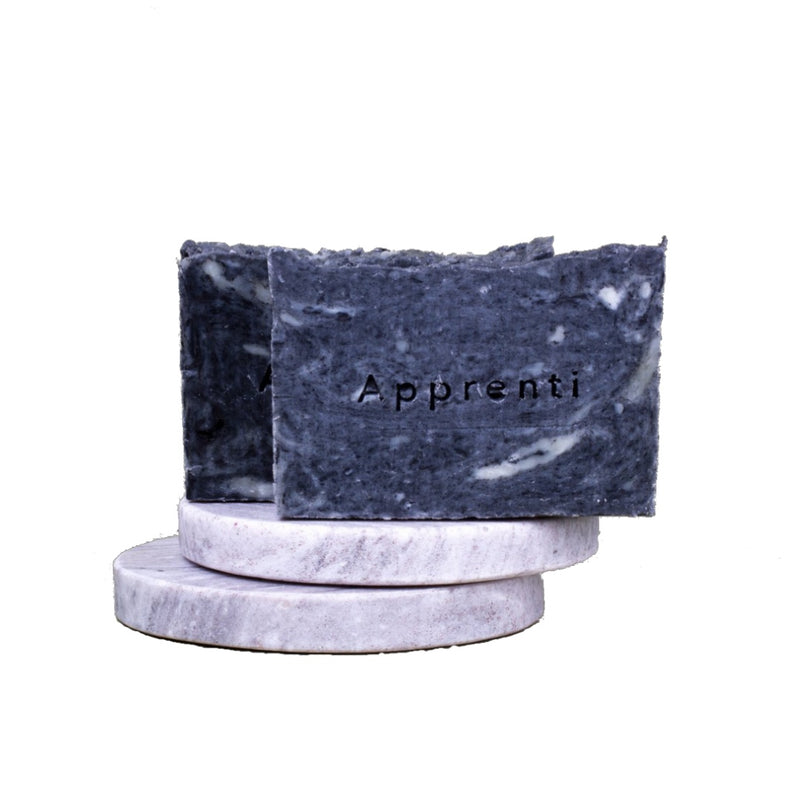 apprenti organik natural herbal detox soap bar on two stone coasters