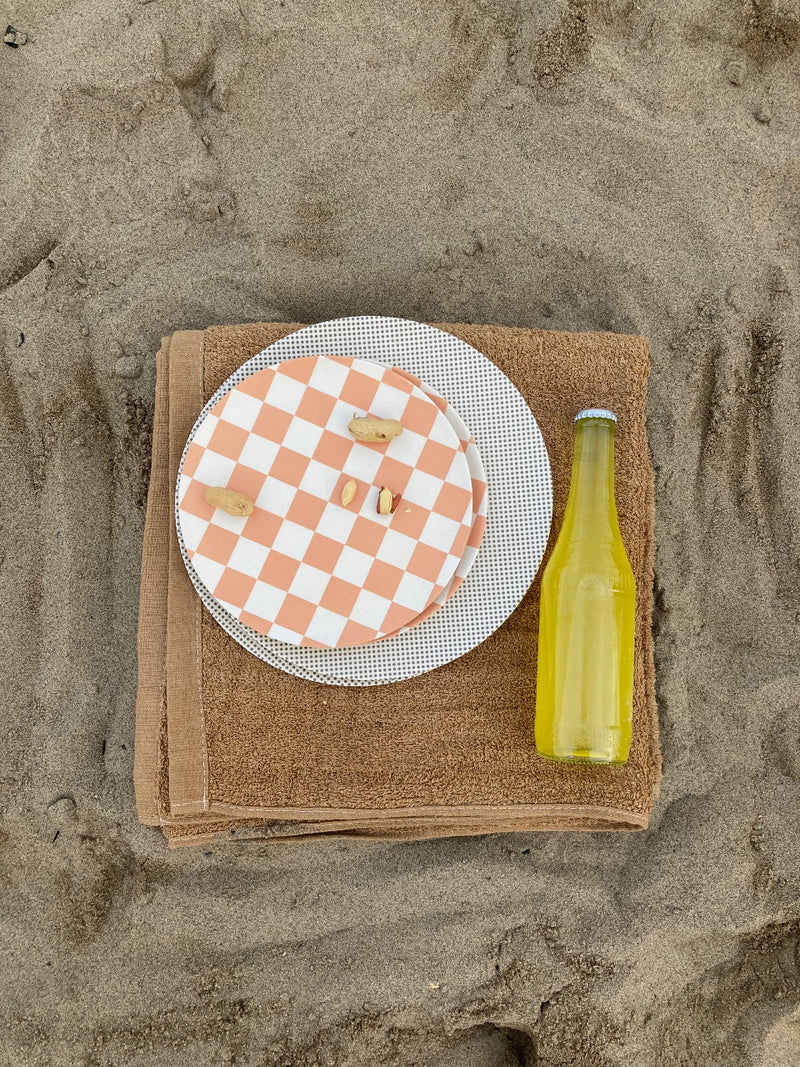 xenia taler side plate coco check and dinner poppet stacked on a towel