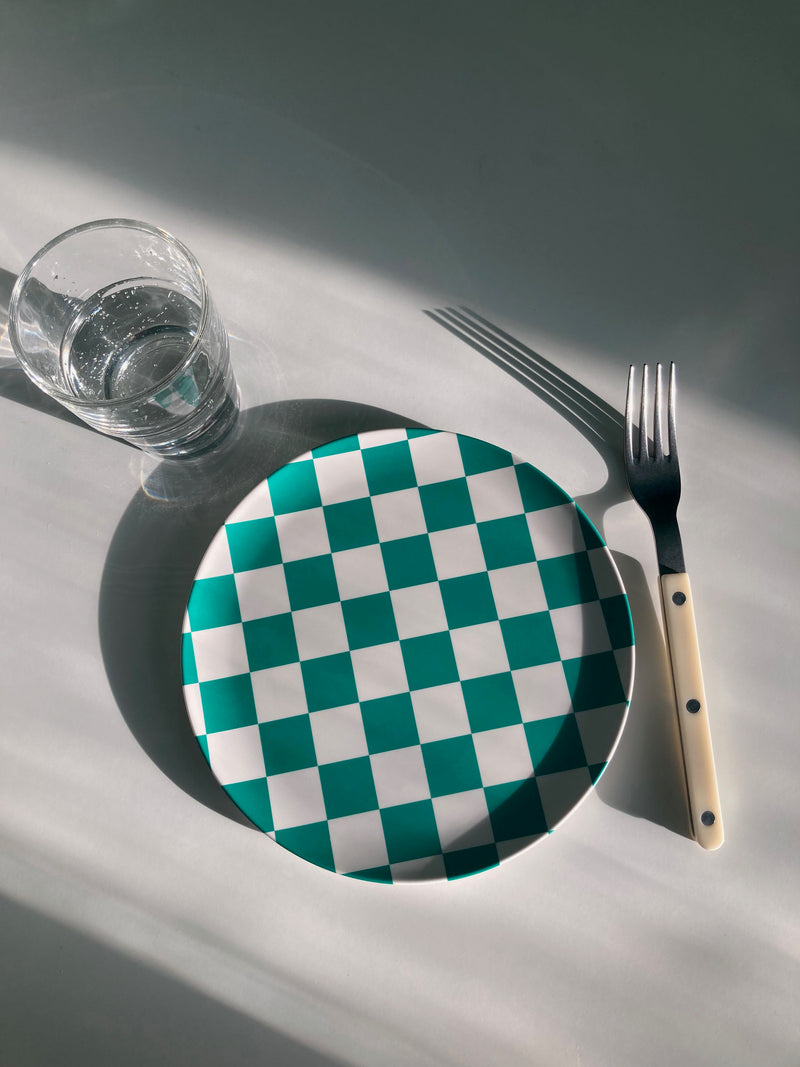 bamboo side plate in green and white checkers on table with fork and water glass
