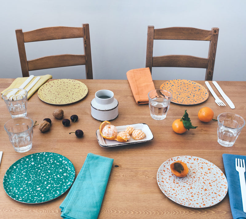 xenia taler bamboo terrazzo side plates set at table with napkins cutlery and fruit