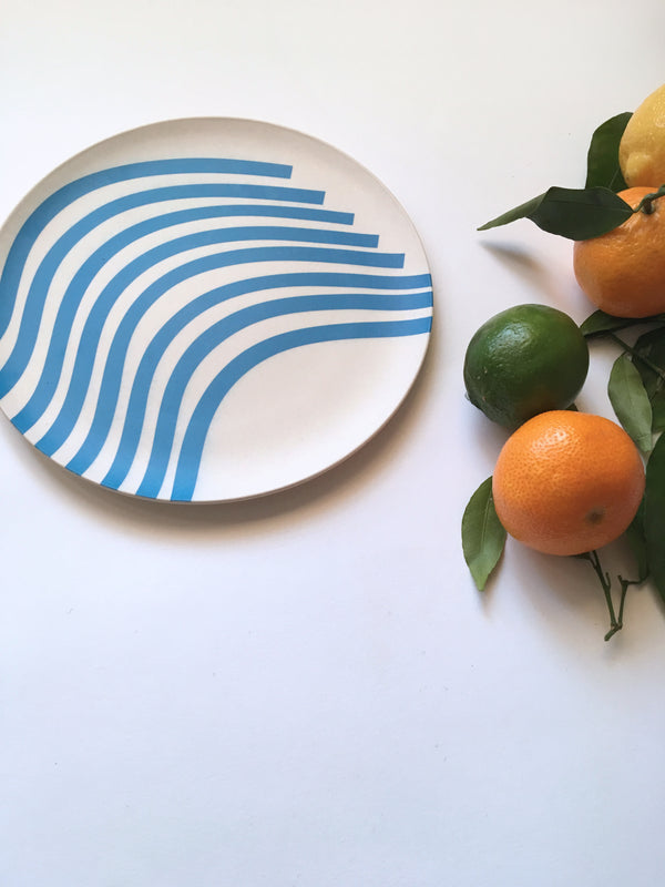 sustainable bamboo side plate marina next to oranges and limes