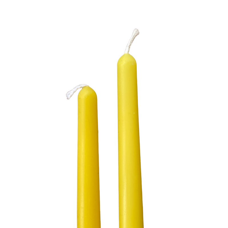 two yellow coloured beeswax taper candles